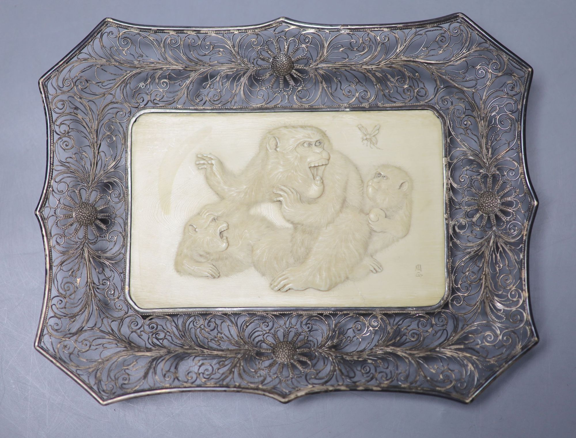 A Japanese Meiji period ivory and white metal filigree work monkey tray, engraved two character signature, 20cm